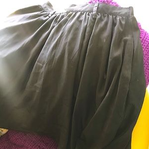 Knee length black pleated skirt with pockets